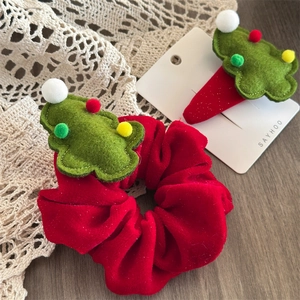 Close-up of red velvet scrunchie and clip set with green felt Christmas tree ornaments