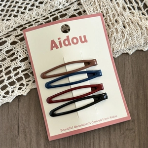 Set of four water-drop hair clips in dark glossy colors on a white product card