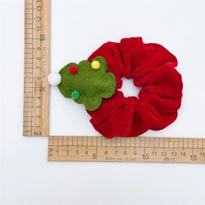 Macro detail of red velvet Christmas scrunchie with green tree decor showing 10cm size