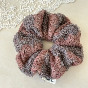 Detailed knit texture and soft pink grey striped pattern on this oversized scrunchie