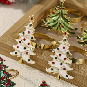 Detailed macro view of enamel Christmas tree napkin rings with inlaid rhinestones