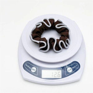 Detail showing the 12.6g weight of this dark brown pleated scrunchie on a scale