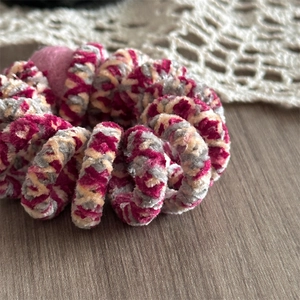 Detail of spiral telephone wire hair tie with soft pink, grey, and cream chenille fur