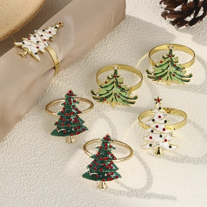 Close-up of Christmas tree napkin rings with colorful enamel and sparkling crystals