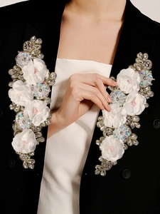 Exquisite 3D fabric flower appliques with sparkling rhinestones on an elegant outfit