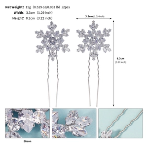 Detail showing two silver zircon snowflake hair pins with 3.3cm width and 8.2cm height measurements