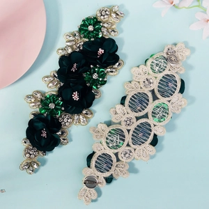 Detailed view of handmade 3D floral applique with green sequins and sparkling rhinestones