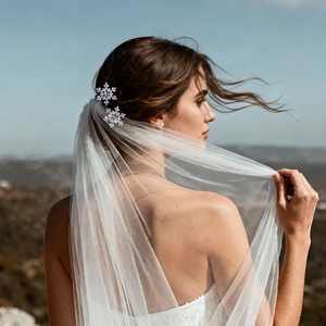 Detailed view of sparkling snowflake bridal hair pins styled in an elegant updo hairstyle