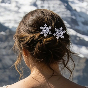 Detail of two snowflake hair pins with sparkling crystals on an elegant hairstyle