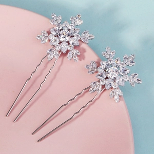 Detailed view of silver snowflake hair pins with sparkling crystals and wave U-shape design