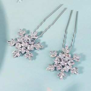 Detail of silver snowflake hair pins with sparkling zircon stones and wavy U-shaped prongs