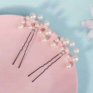 Handmade pearl hair pins set with white beads on black U-shaped clips for bridal styling