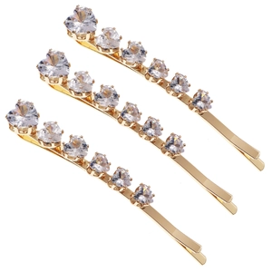 Three-piece gold heart hair clip set with sparkling zircon crystals on white background