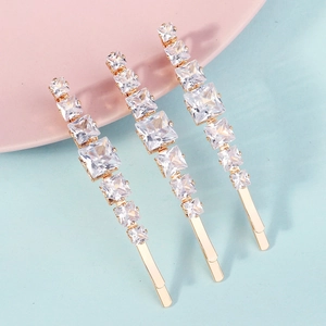 Three-piece gold hair clips with gradient princess cut crystals for elegant party hairstyles