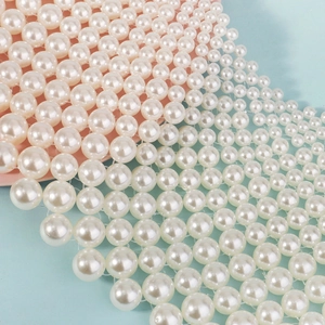 Macro view of multi-layered pearl mesh beads for elegant dress and shawl decoration