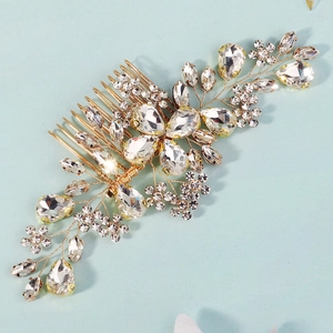 Macro shot of gold wedding hair comb with crystals and intricate floral wire weaving