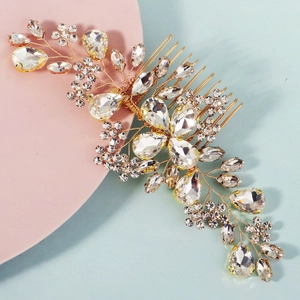 Detail of handcrafted gold floral hair comb with clear crystals and rhinestones
