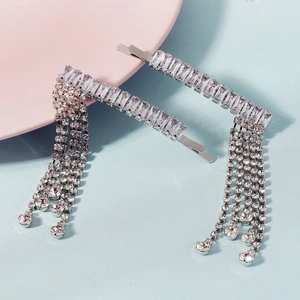 Silver fringe hairpin with rectangular rhinestones and long tassels on blue background