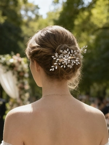 Detail view of a handcrafted bridal hair comb with gold wire and sparkling rhinestones