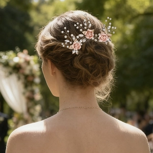 Detailed view of handmade pink rose hairpins with pearls and crystals on bridal updo
