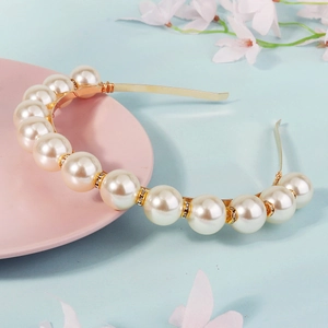 Elegant vintage faux pearl headband with sparkling rhinestones on a gold metal frame