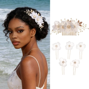 Detailed close-up of bridal hair comb set with white fabric flowers and pearls