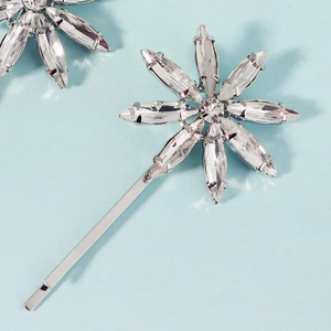 Detailed view of silver flower hair clip with sparkling marquise crystal petals