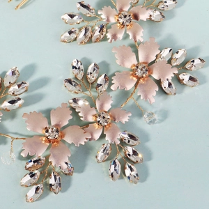 Handmade bridal hair comb with rose gold metal flowers and crystal leaves for weddings
