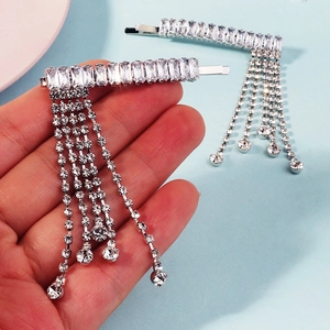 Close-up of sparkling rhinestone tassel hair clip with silver metal base for elegant parties