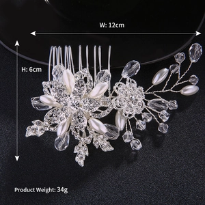 Macro detail of bridal hair comb with silver flower, crystal pearls and size labels
