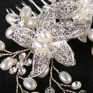 Luxurious bridal hair comb with pearls and rhinestones on elegant black fabric