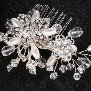 Detailed close-up of bridal flower hair comb with white pearls and crystal tassels
