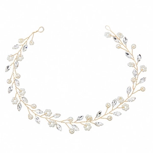Detail of a handmade bridal hair vine with white pearls and sparkling crystal flowers