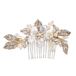 Detailed close-up of bridal hair comb with gold floral motifs, pearls and rhinestones