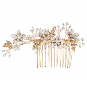 Close-up of golden bridal hair comb with white flowers, pearls and crystals