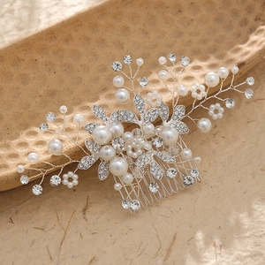 Handmade bridal hair comb with elegant white pearls and rhinestones on a silver floral base