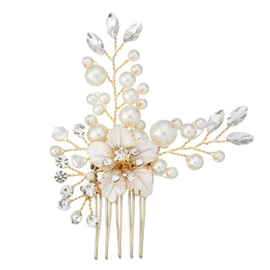 Macro detail of bridal hair comb with cream flowers, white pearls, and leaf rhinestones