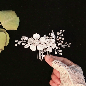 Silver bridal hair comb with elegant metallic flowers, white pearls and sparkling rhinestones