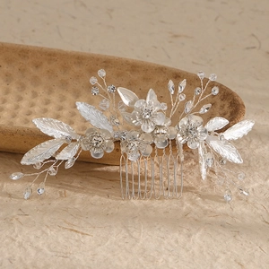 Close-up of silver flower hair comb with frosted leaves, crystals, and 5-tooth metal base