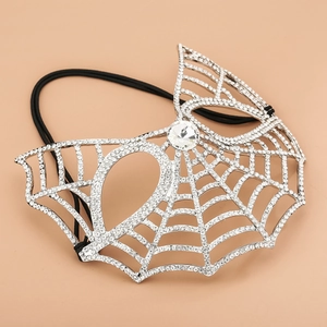 Detailed view of silver spiderweb masquerade mask with sparkling rhinestones and elastic strap