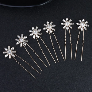 Set of six gold U-shaped bridal hair pins with shimmering crystal flower details