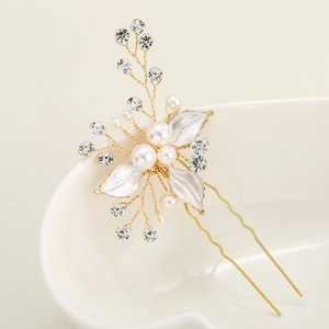 Elegant bridal hair pin with white leaves, pearls, and crystals on a golden U-shaped clip