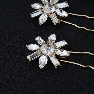 Elegant gold flower hair pins with sparkling crystals and U-shaped design for bridal styling