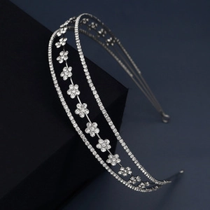 Detail of silver double-layer headband with floral rhinestones on dark display