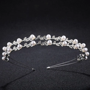 Detail shot of silver double-layered headband with pearls and rhinestones on black background