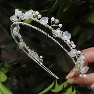 Detail view of handmade flower headband with matte petals, pearls and crystal beads
