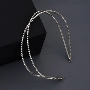 Detail of silver crisscross headband with sparkling rhinestones on a geometric prop