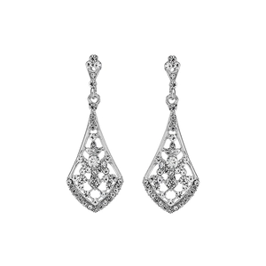 Detailed macro view of silver alloy drop earrings with hollow geometric patterns and rhinestones