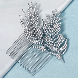 Detail of silver alloy bridal hair combs featuring leaf designs and sparkling white rhinestones