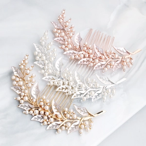Detail of three bridal hair combs in gold, silver, and rose gold with rhinestones and pearls